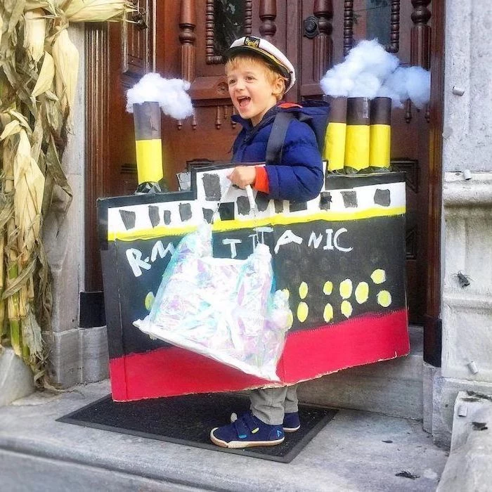 titanic ship, made of carton, boy dressed as the captain, childrens halloween costumes, large wooden door