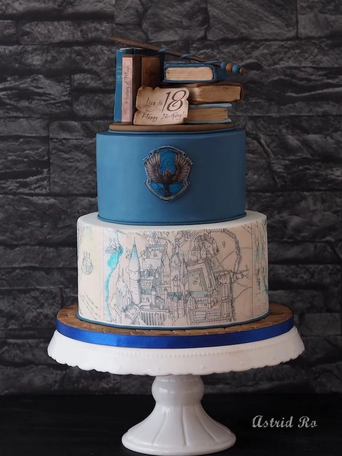 two tier ravenclaw cake, harry potter birthday cake hagrid, made with blue and white fondant, books and wand toppers