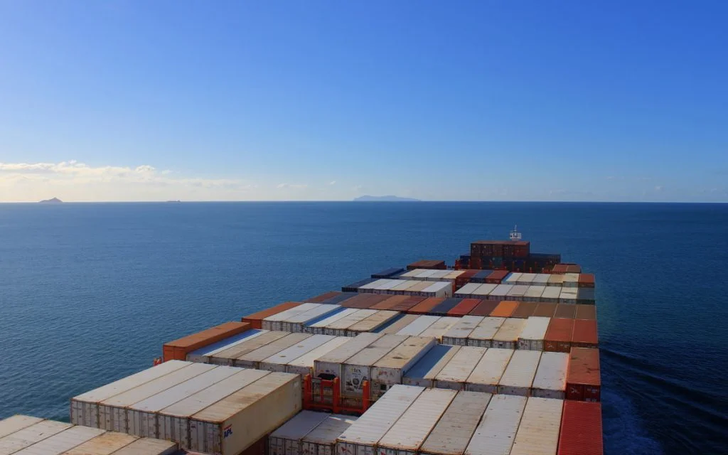 A freighter leaving the coast of New Zealand to the Pacific Ocean.