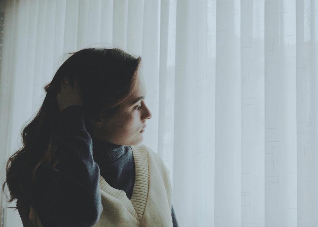 Projecting Emotions: Are Those Your Feelings or Theirs? by Holly Schaefer. Photograph of a woman looking out the window by Isabela Drasovean