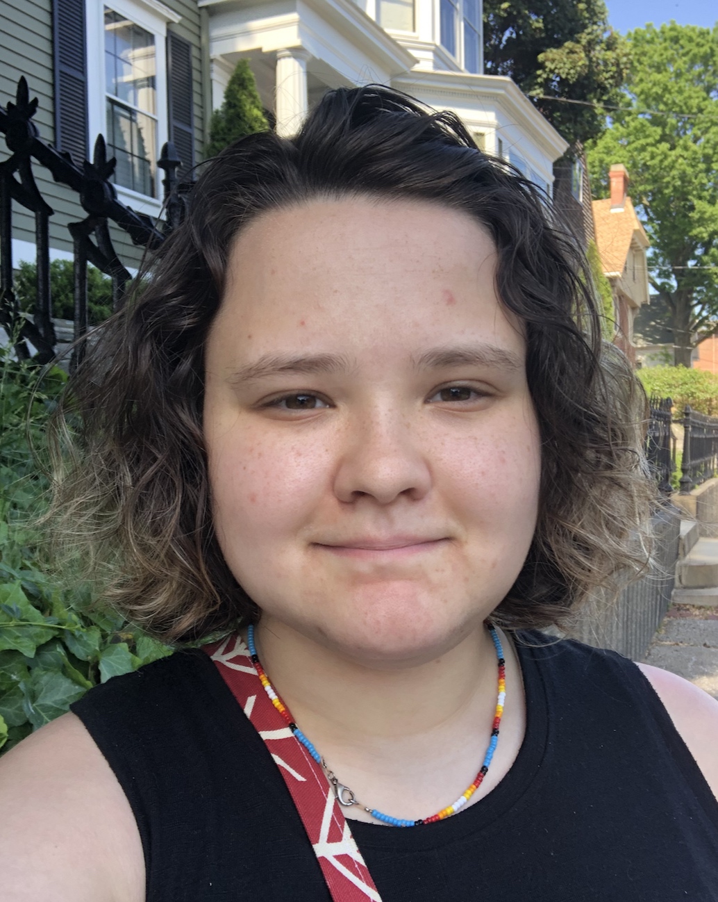 Laney Day headshot, wearing a black shirt and bead necklace.