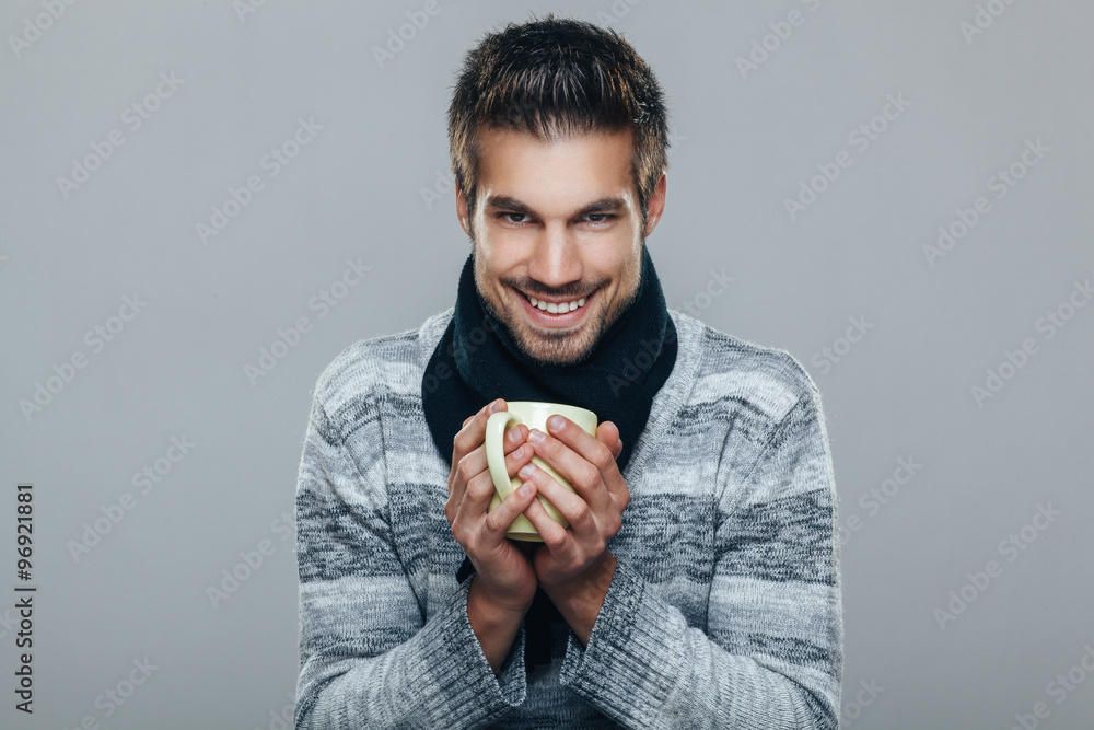 Young man holding cup of tea