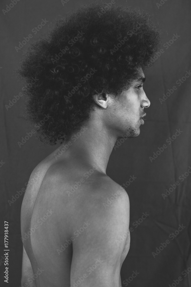 Black and white portrait of a young afro man.