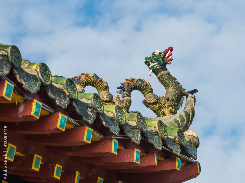 Vietnam, Hoi An. Old town historic district (UNESCO World Heritage Site). Fujian (Phuc Kien) Assembly Hall, built around 1690. Dragon sculpture on roof line.