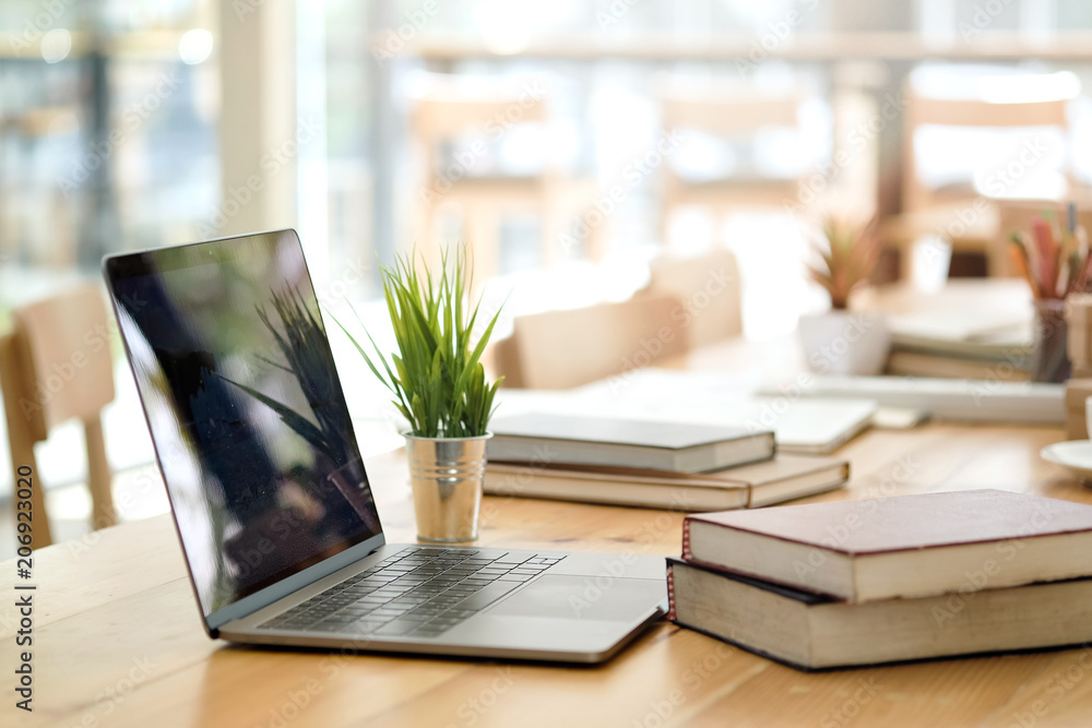 Desk with laptop, books and business office background. Stock Photo | Adobe  Stock