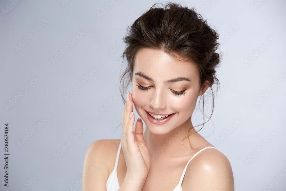 cute girl with natural make-up smiling and looking down