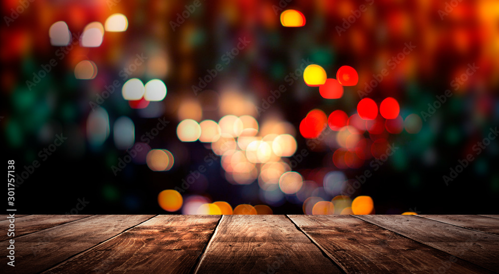 Wooden table, blurred bokeh background background. Neon light, night view, close-up. The general background of the interior, a dark background.