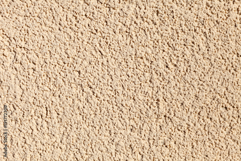 wall with a textured plaster of beige color. Background image, texture.  Stock Photo | Adobe Stock