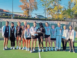 The 2024 Quaker Valley girls tennis team poses with the trophy after finishing runner-up to North Catholic in the WPIAL Class 2A championship.