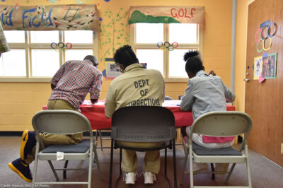 A woman held at the Pulanski State Prison in Georgia plays with her children in the prison's Children Center.