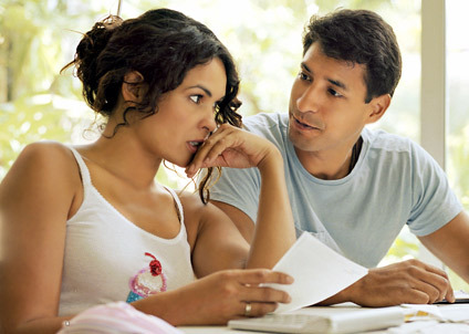 Stressed pregnant woman holding her forehead and receiving comfort from her partner