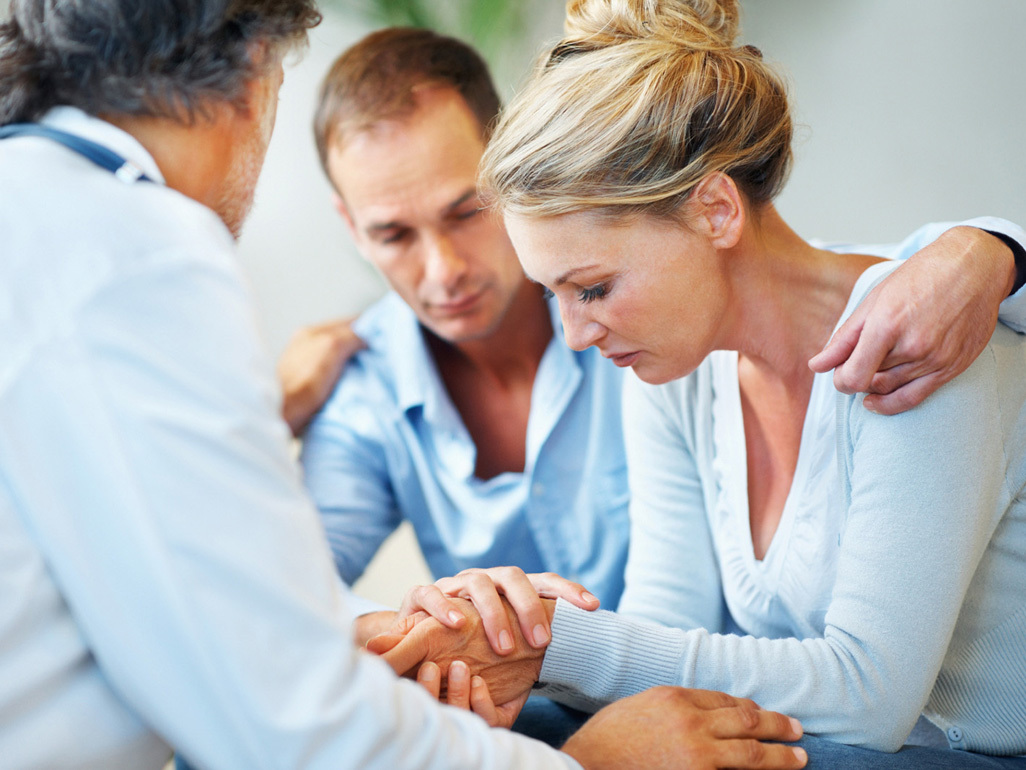 Upset couple with doctor