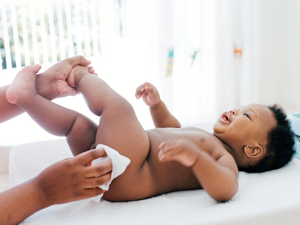 happy baby having diaper changed