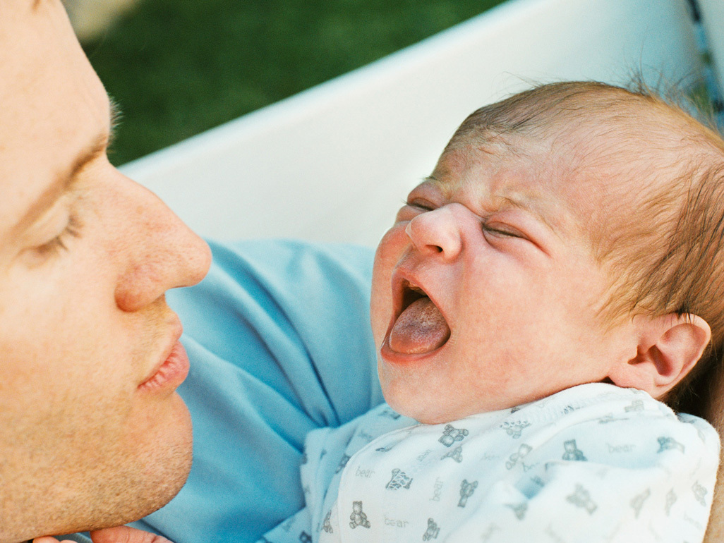 Dad holding crying baby