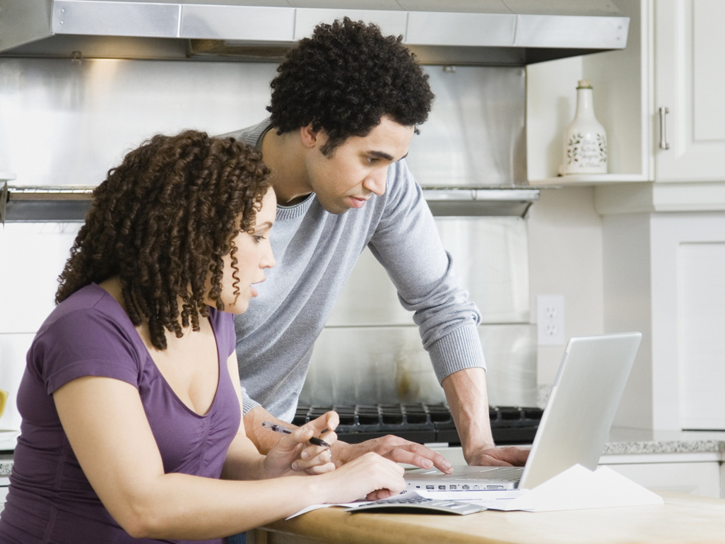 Couple sitting at computer writing their birth plan