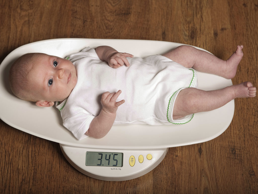 baby laying on a digital scale