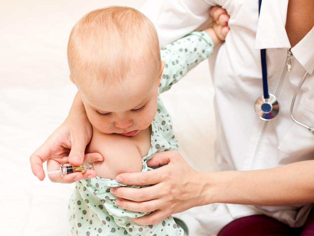 Doctor giving baby injection