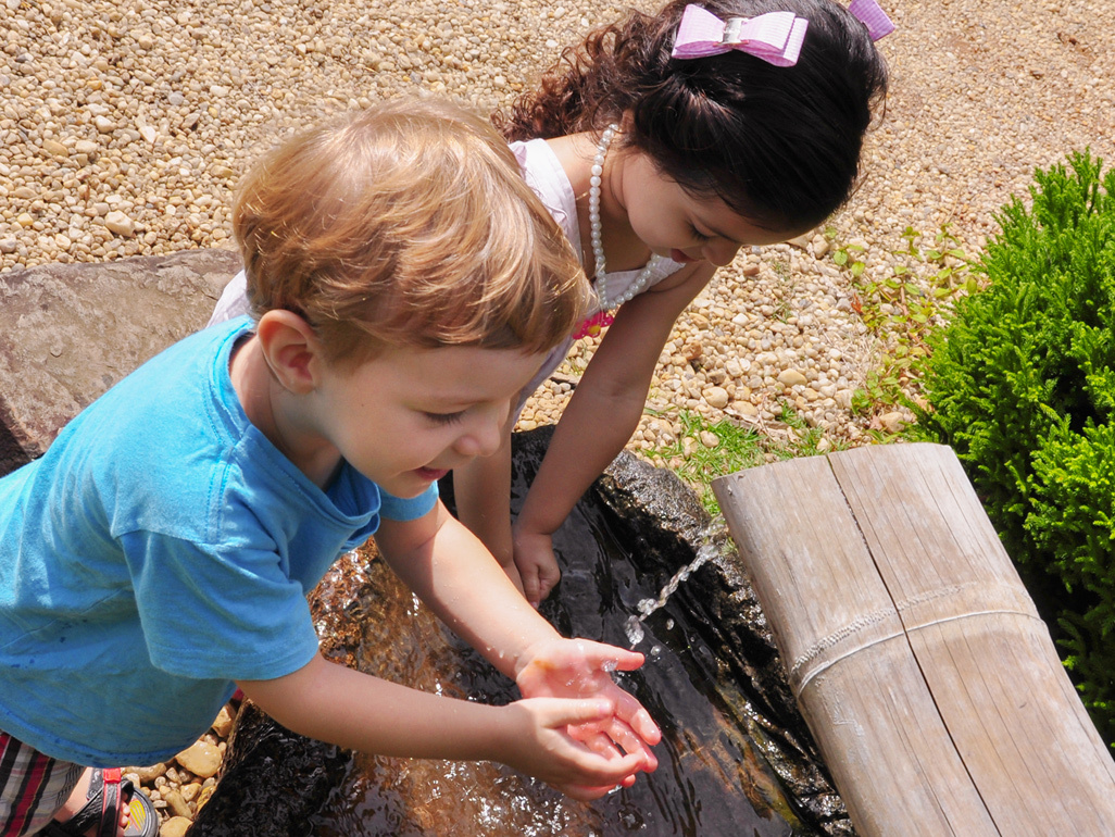 two kids playing with water