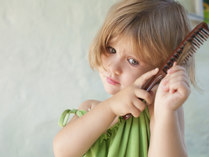 girl in a dress brushing her hair