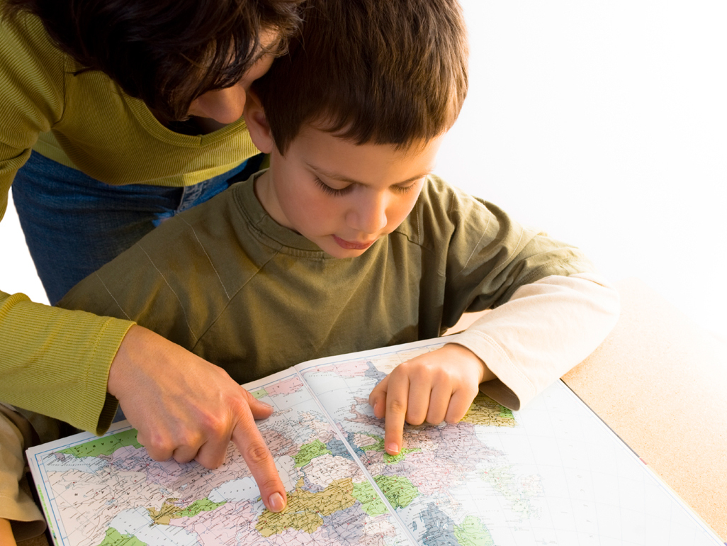 woman helping boy to read