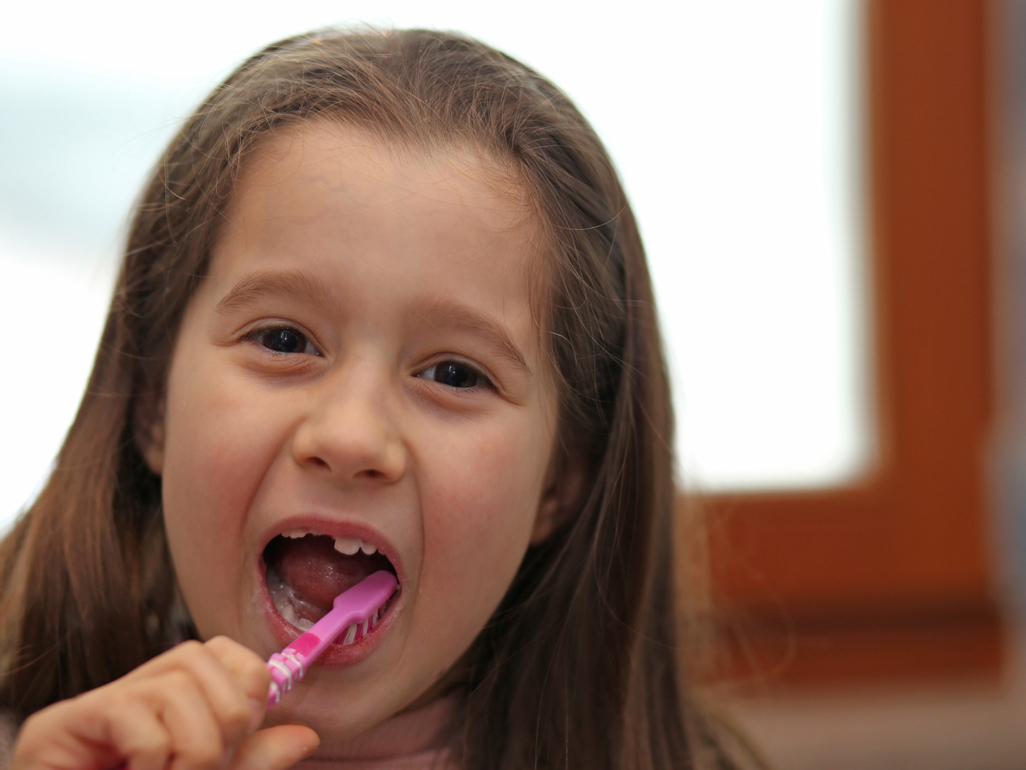 girl brushing her teeth