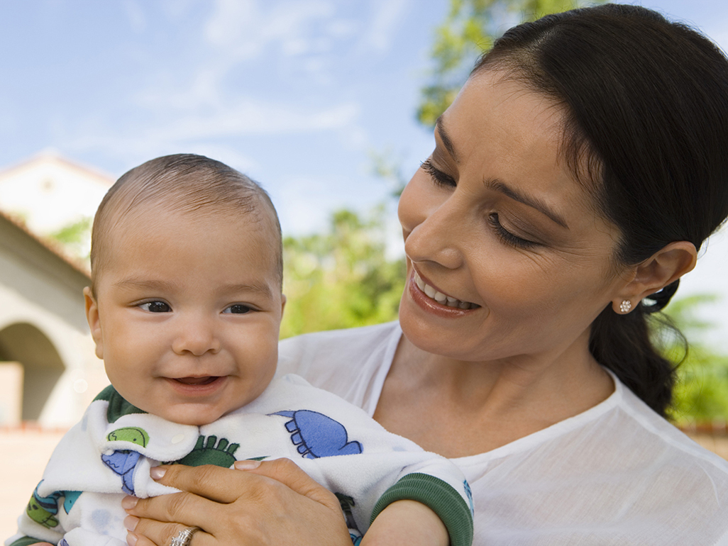 A woman holding a smiling baby