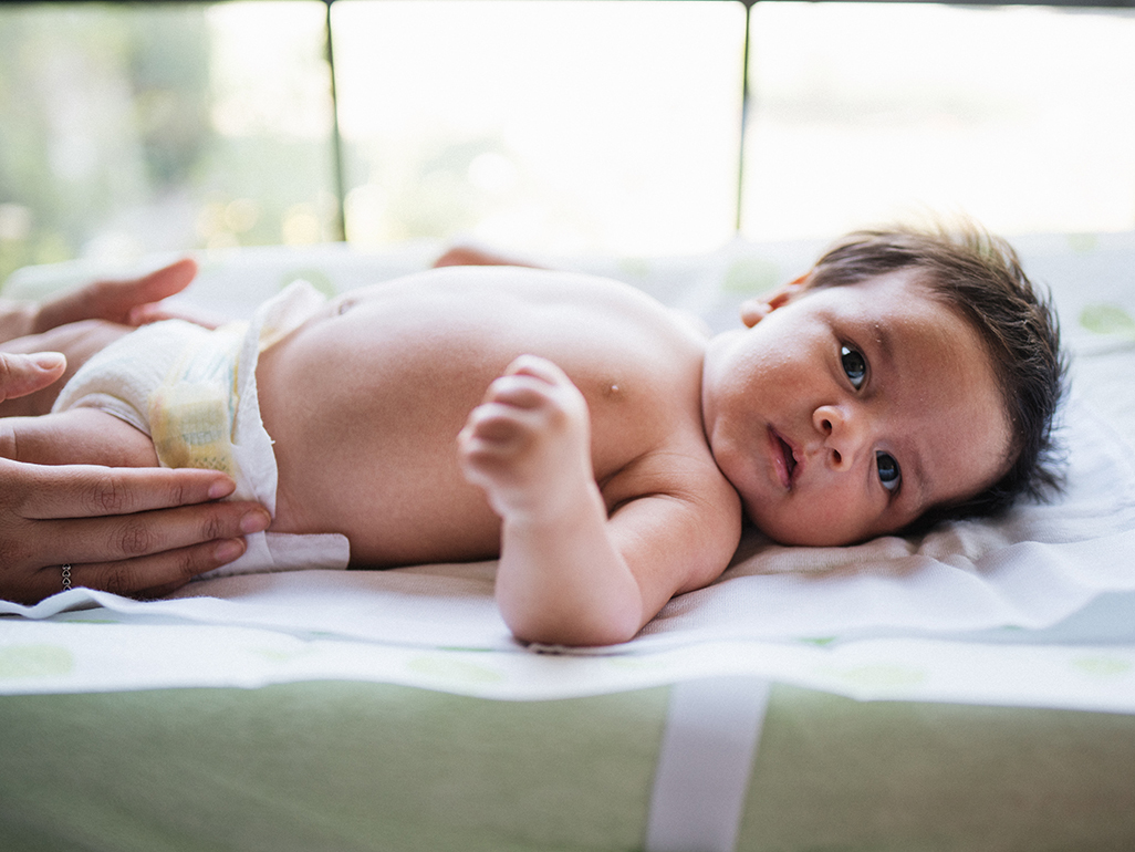 Mom changing baby's diaper