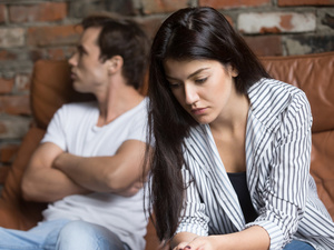 Couple arguing on a sofa