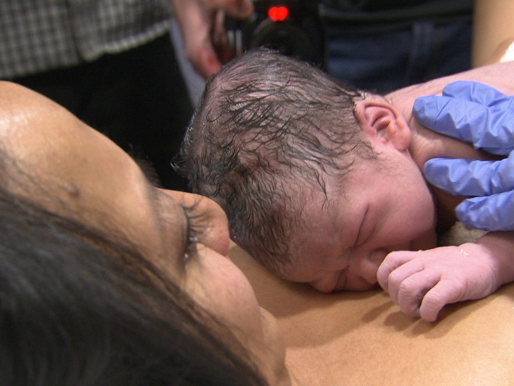 fresh newborn laying on mom's chest