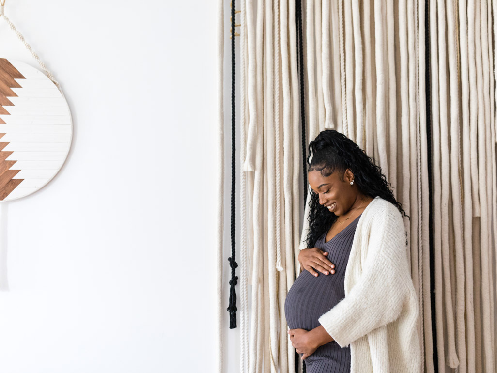 Pregnant woman looking at her bump