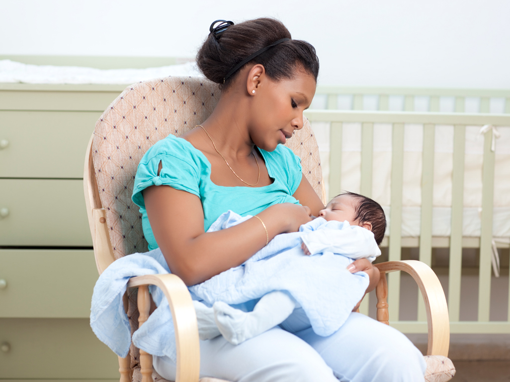 Happy mum breastfeeding baby