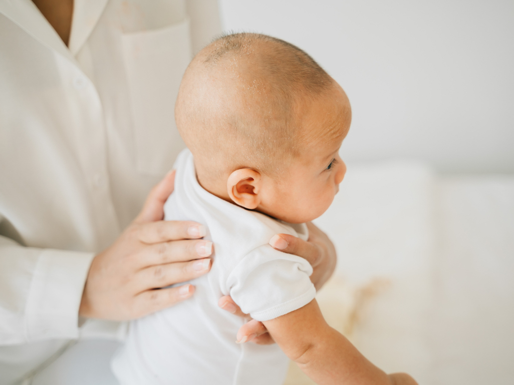 Mom patting infant's back 