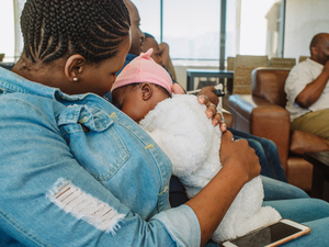 Mother breastfeeding infant in waiting room