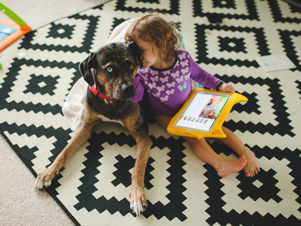 Child on ipad with dog