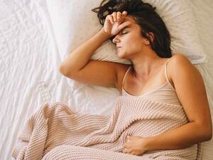 Stressed lady lying on her bed