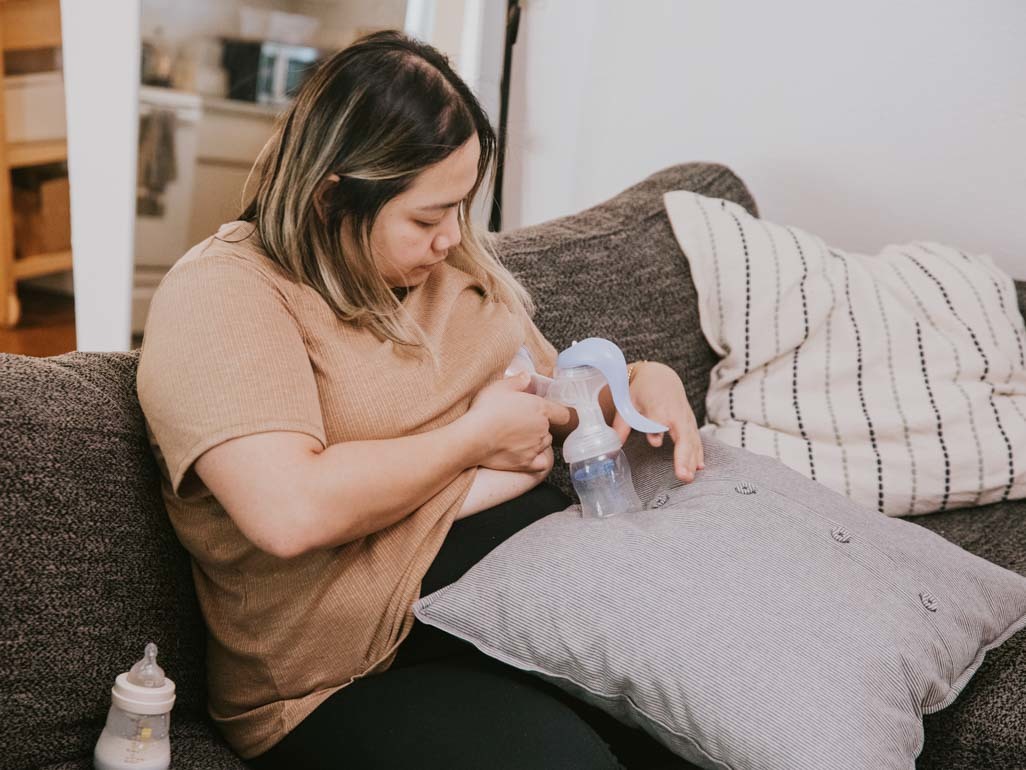 Woman expressing breastmilk