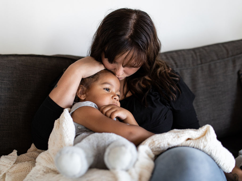 a mom comforts her child, the text reads: BabyCenter Answers, RSV in babies