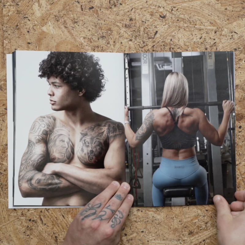 Professionally designed magazine opened up to show two people, one working out at the gym and another showing off tattoos