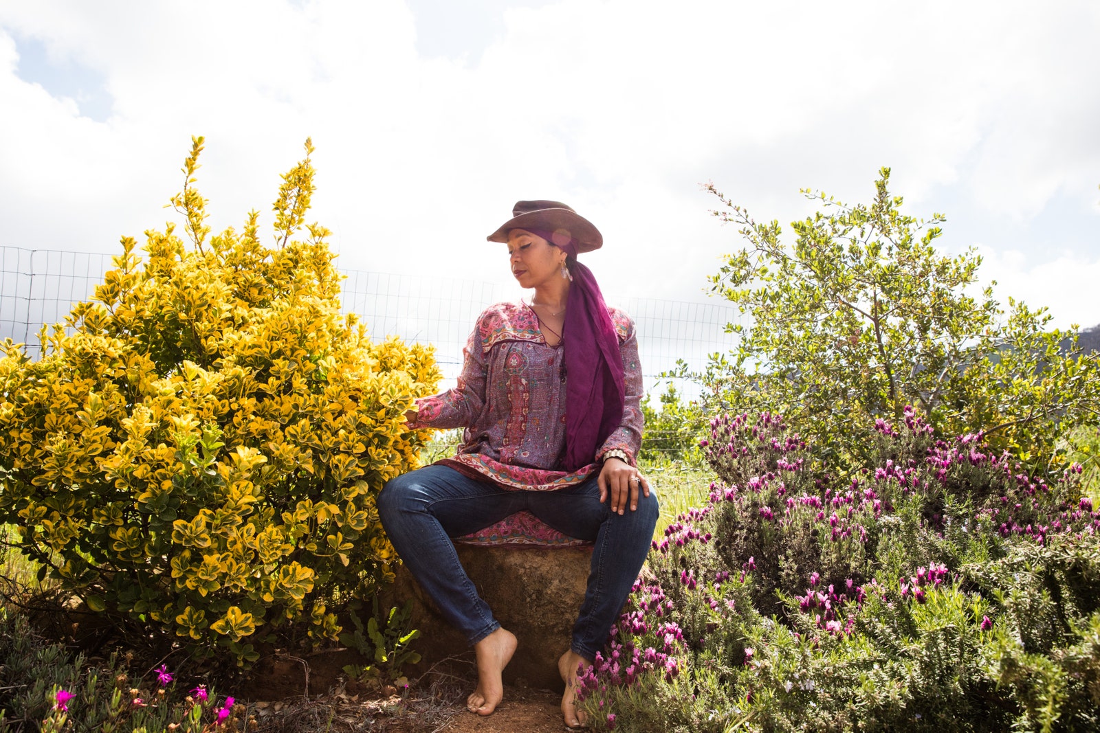 This image may contain Clothing Apparel Human Person Garden Outdoors Plant Flower Blossom Hat and Sun Hat