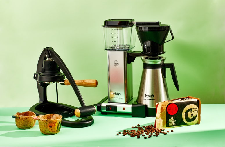 A selection of gifts for coffee lovers: a Moccamaster, Boon Boona beans, ceramic mugs, and a Flair espresso maker