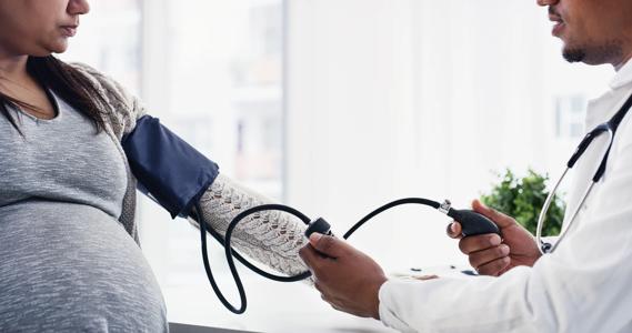 pregnant woman having blood pressure checked