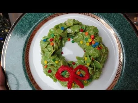 Festive green wreath dessert with colorful sprinkles and a red bow.