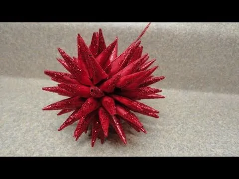 Red spiky decorative object on a textured surface.