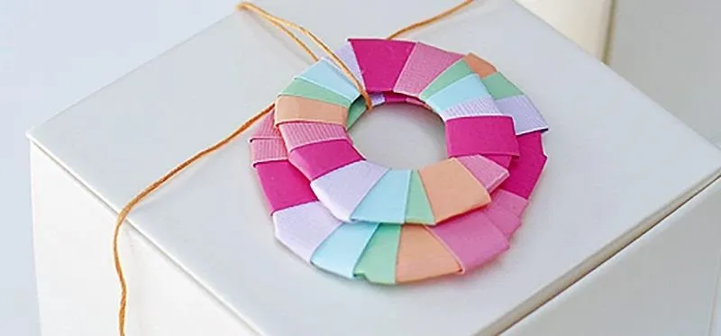 Colorful origami necklace on a display.