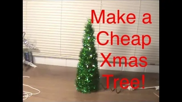 Small artificial Christmas tree with a message about making a cheap Xmas tree.