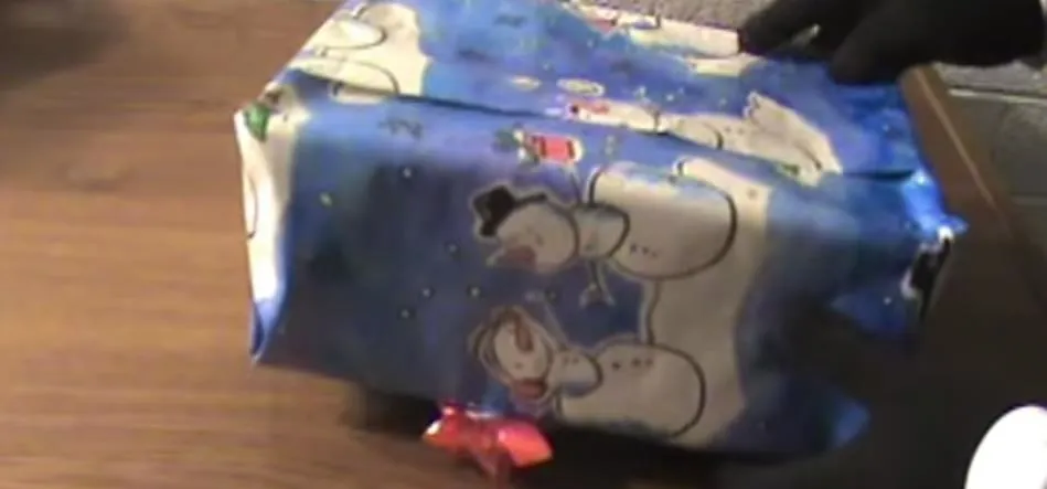 Wrapped gift with festive snowman design.