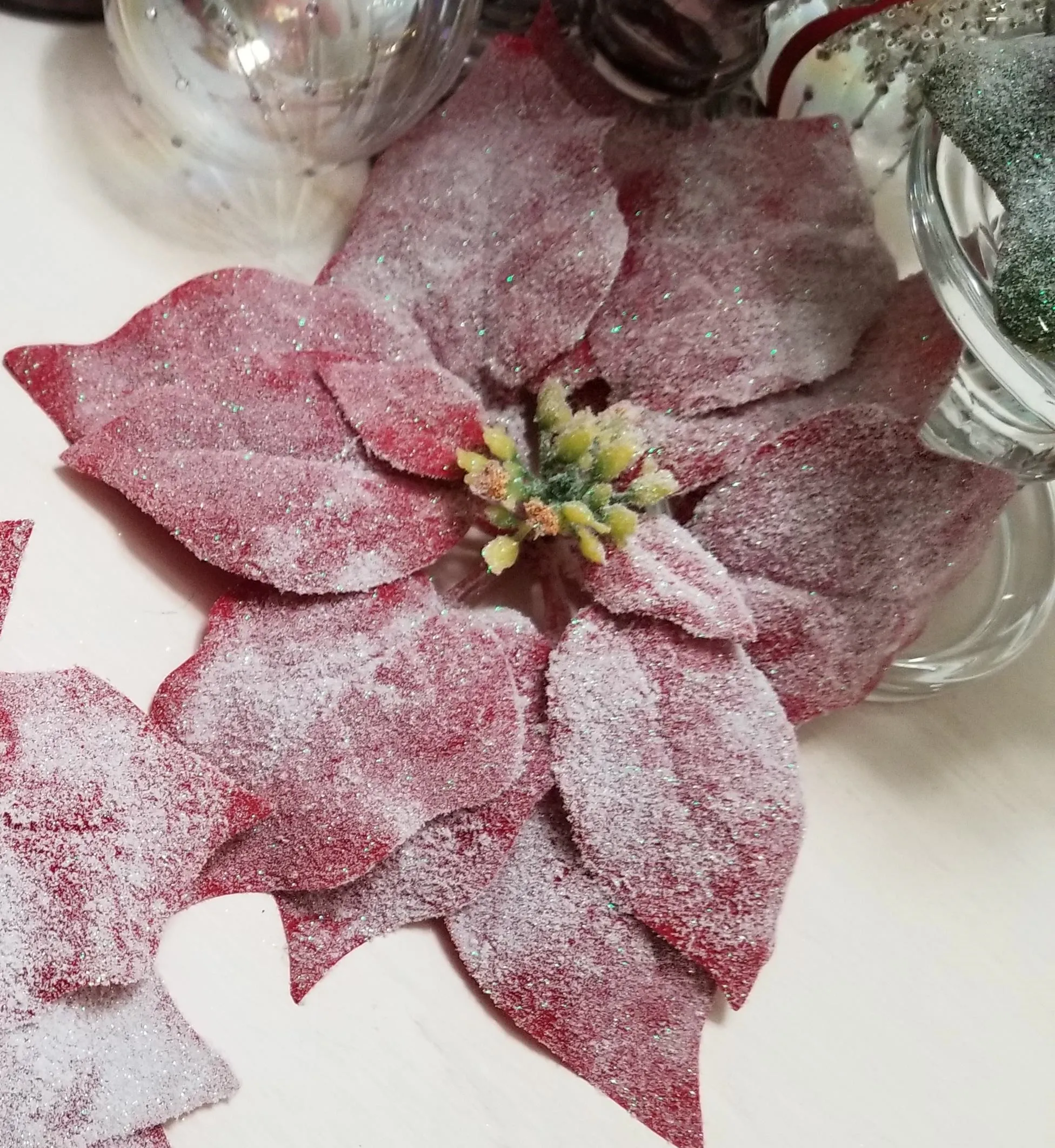 Pink decorative flower with glitter accents.