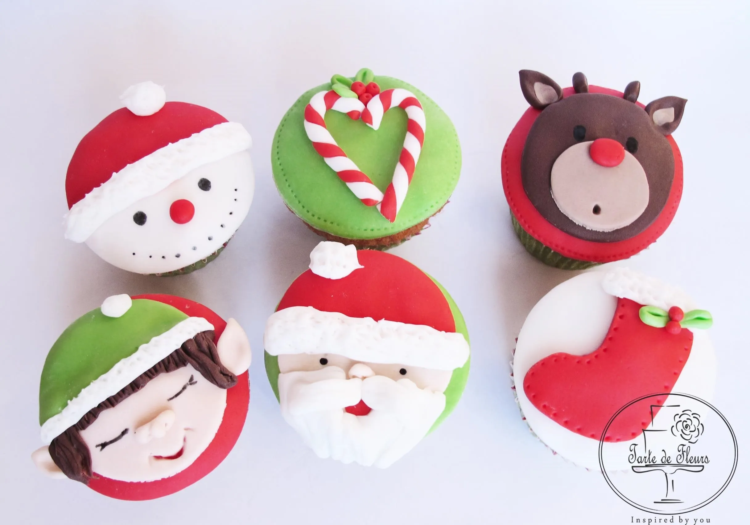 Festively decorated Christmas-themed cupcakes.