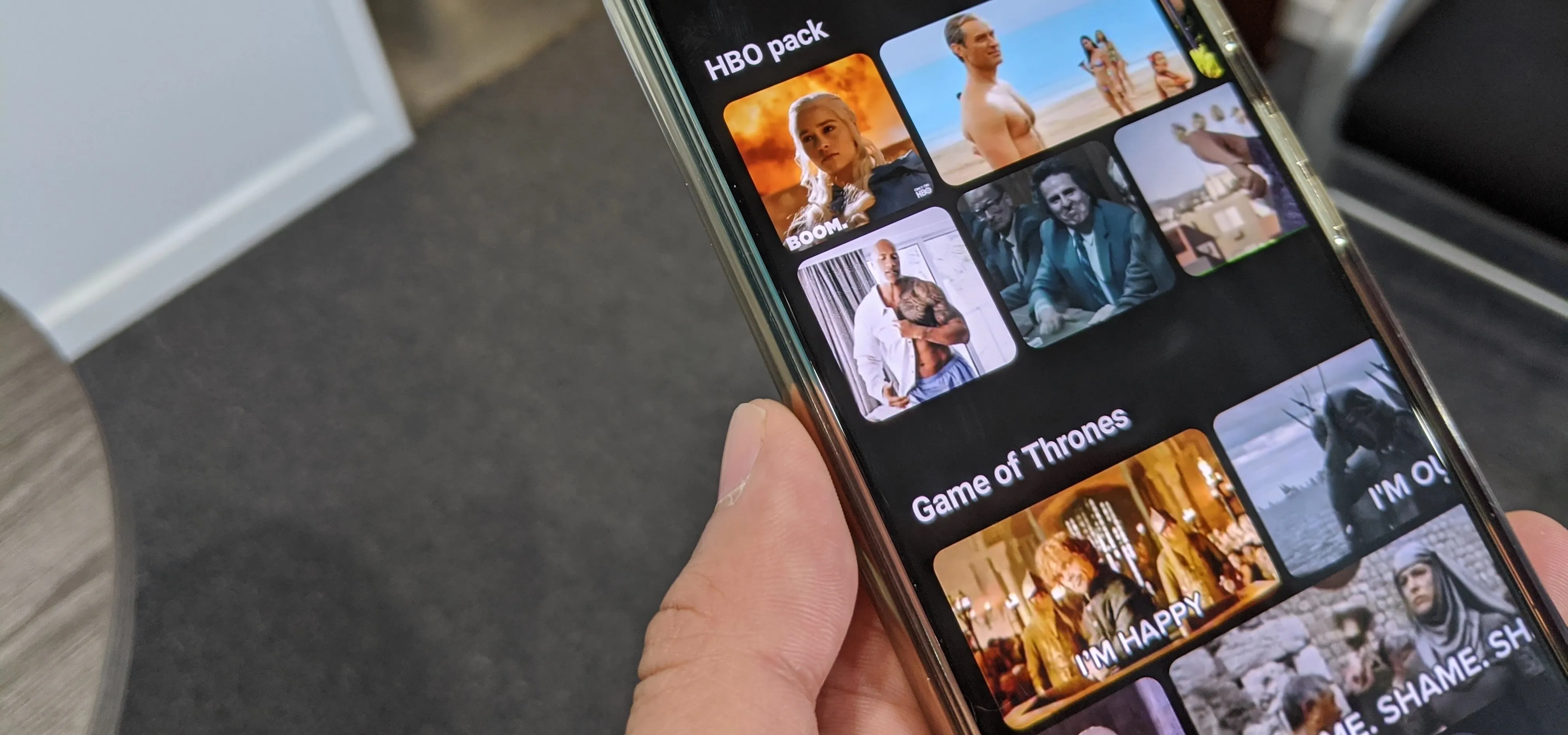 Image of a smartphone displaying various media thumbnails, including content from "Game of Thrones."