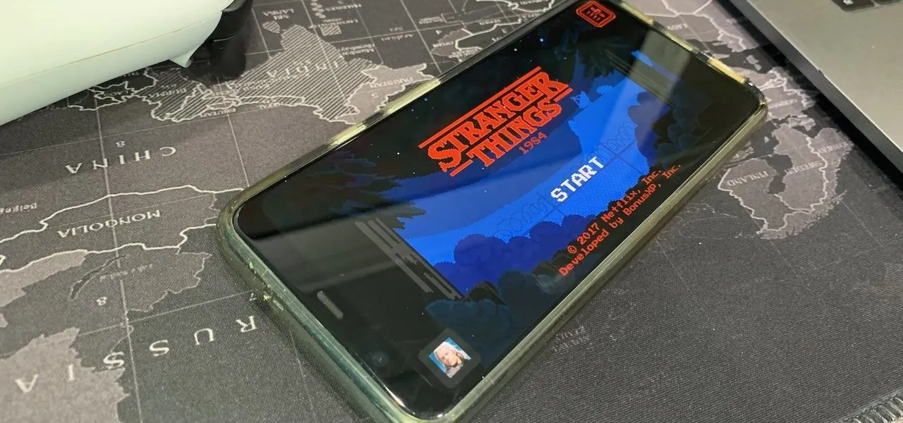 A smartphone displaying the title screen of the game "Stranger Things".